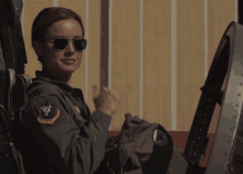 A woman pilot giving a thumbs up